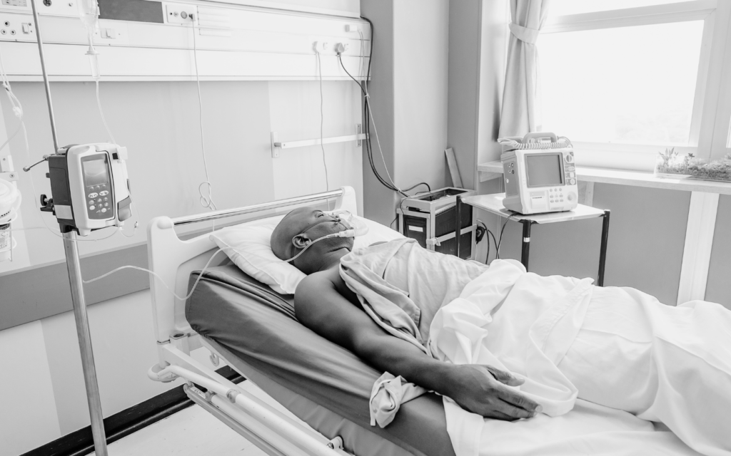 Man in a hospital bed recovering from a surgical mistake.